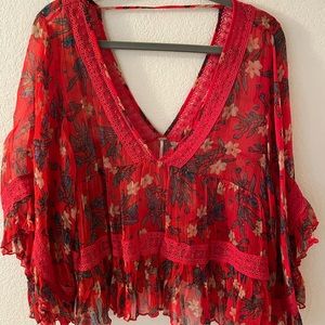 Free People sheer floral blouse w/crochet detail.